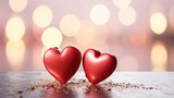 Two red hearts together on a soft white surface with a romantic pink bokeh background symbolizing love and Valentine's Day