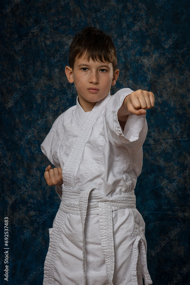 Boy in fighting position in white kimono. Aikdo Boy in fighting position in white kimono. Aikdo