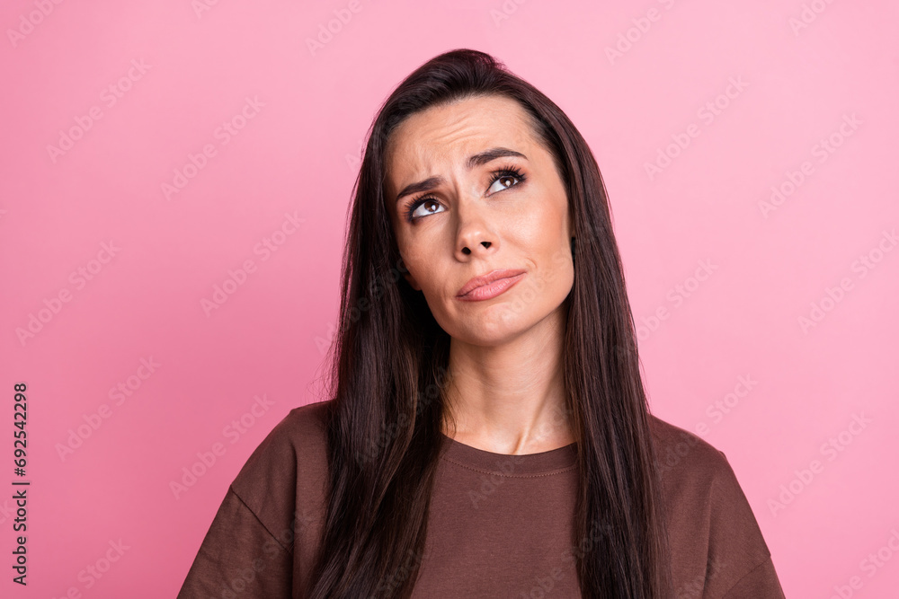 Photo of minded gorgeous person look interested empty space contemplate isolated on pink color background Photo of minded gorgeous person look interested empty space contemplate isolated on pink color background