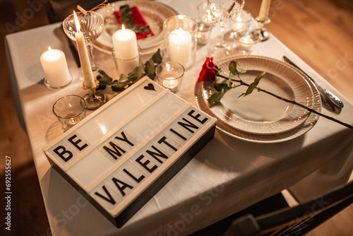 holidays, valentine's day and celebration concept - close up of festive table serving with be my valentine words on light board at home at night