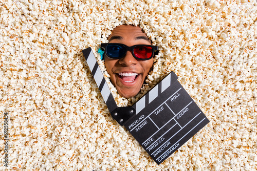Top view photo of crazy positive guy in pop corn advertise new holywood cinema film isolated background photo