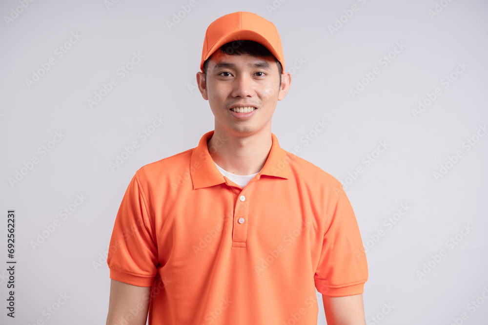 Delivery Concept - Portrait of Happy asian delivery man showing thumbs up. Isolated on Grey studio Background.