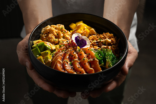 Chef Presenting a Vibrant Poke Bowl photo