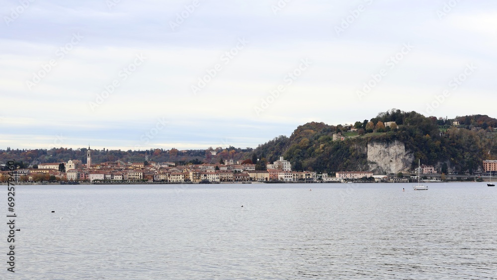 View from lake front of Arona, Lake Maggiore, Piedmont, Italy. November 2023 cloudy day.