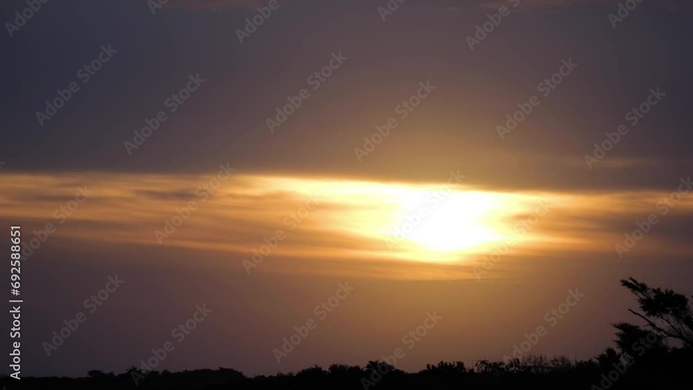 Setting sun from Pea Island National Wildlife refuge, Outer Banks, North Carolina with various birds in flight. Setting sun from Pea Island National Wildlife refuge, Outer Banks, North Carolina with various birds in flight.