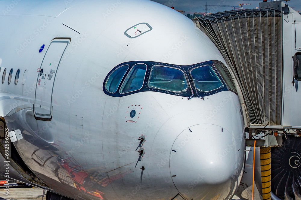 An Airbus A350-900, this is a large new generation wide-body aircraft, ideal for long-range travel, parked and ready to take off and start a trip.