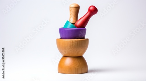 a solo wooden mortar and pestle set, each uniquely colored, against a pristine white backdrop.
