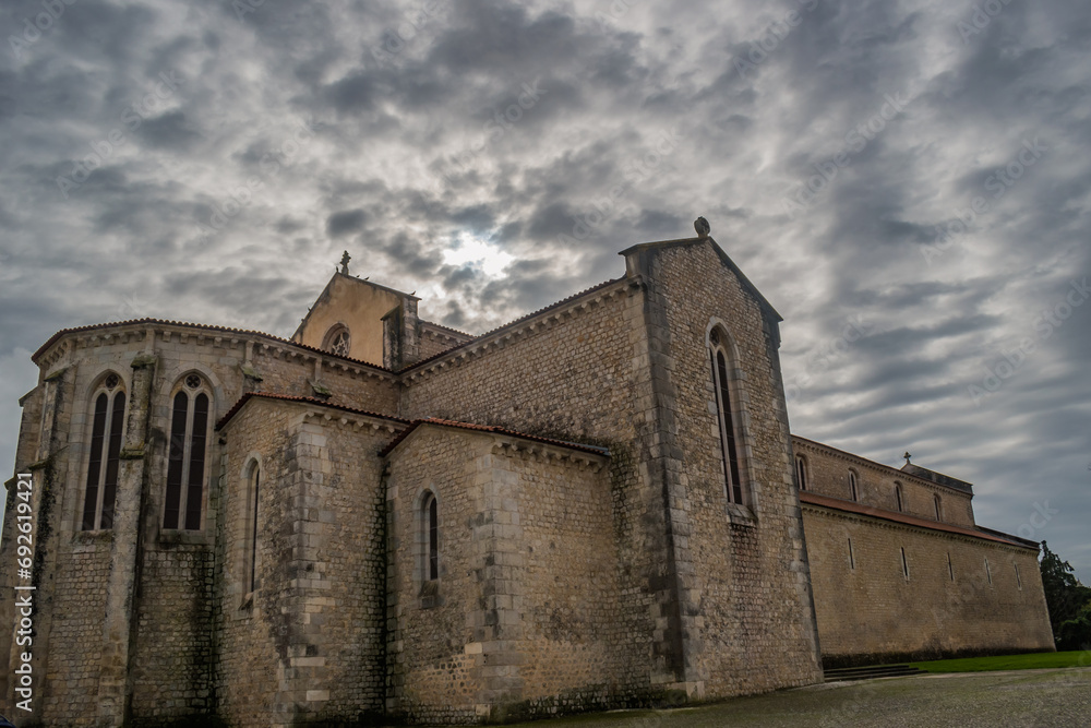 Buttress and transept of the gothic Santa Clara church in perspective with cloudy sky, Santarém PORTUGAL