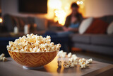 Popcorn on a coffee table with cozy lights in the background