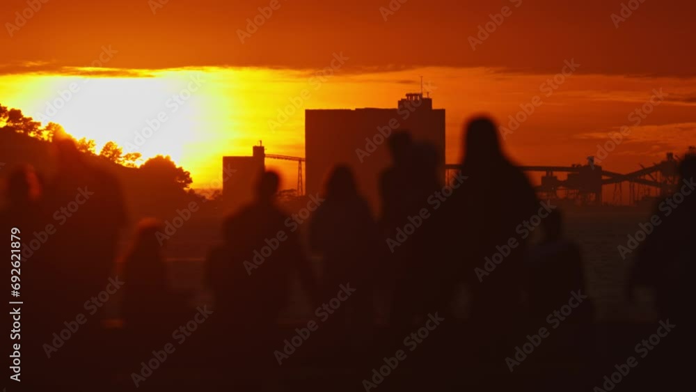 Group of People Silhouetted Against a Vibrant Sunset Group of People Silhouetted Against a Vibrant Sunset