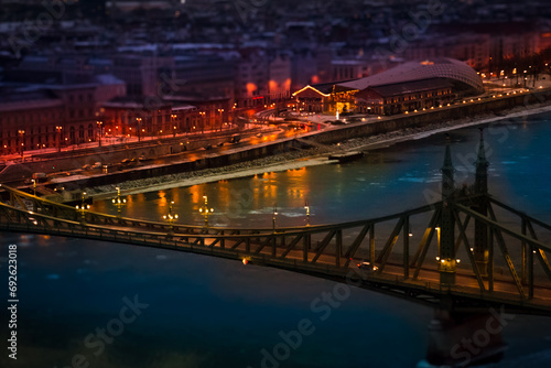 The magic panorama of the city at dusk, river, bridge and city lights. Budapest Hungary, tilt-shift effect, toned