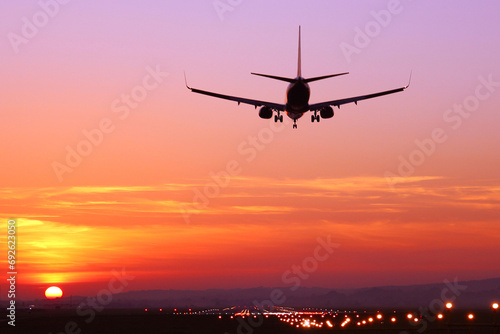 The plane lands at dusk at sunset
