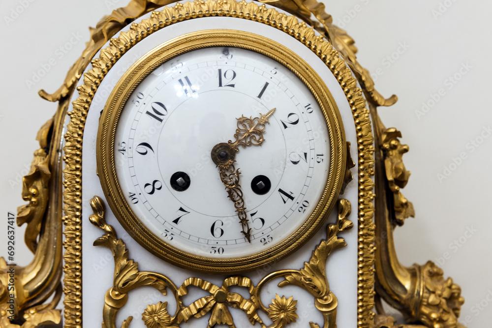 Vintage chiming mantel clock, close up photo, front view. White clock face