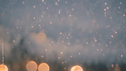 Snow snowflakes particles falling on snow cover. Snow falling on sonw ground bokeh background. Winter wonderland and tranquility. photo