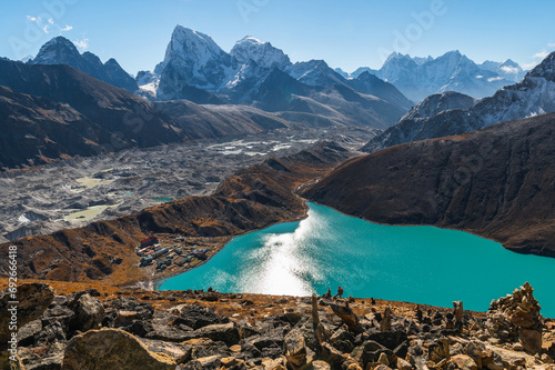 View of Village and Lake Gokyo, snow capped Cholatse and Taboche mountains of the Himalayas and Ngozumpa Glacier during EBC treekking. View from Gokyo Ri, Solukhumbu, Sagarmatha, Nepal. photo