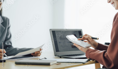 Businessman and team analyzing financial statement Finance task. with smart phone and laptop and tablet. Wealth management concept at office	 photo