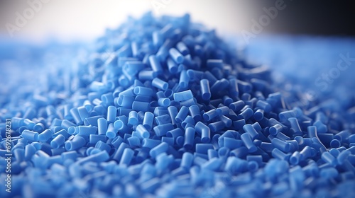 Close up of a two stacks of blue plastic polypropylene granules on a table photo