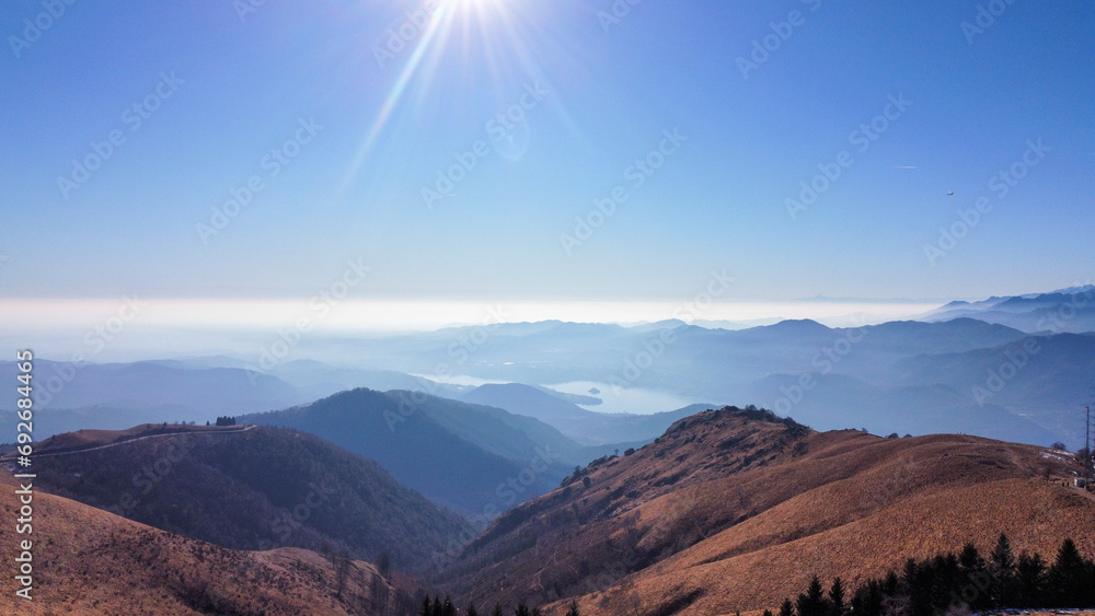 Landscapes with mountains and lakes. Area view with shades of colors, blue water and green meadows Landscapes with mountains and lakes. Area view with shades of colors, blue water and green meadows