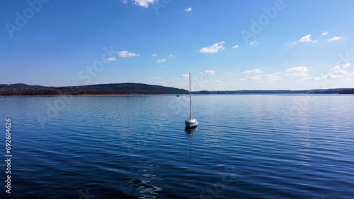 Sailing boat in Italy, Lombardia, Angera on the Lago Maggiore; In the background the mountains