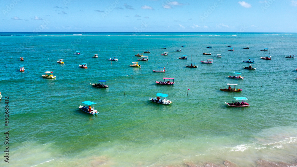 Obraz premium Colorful boats floating on the water in San Miguel de Milagres in Brazil.