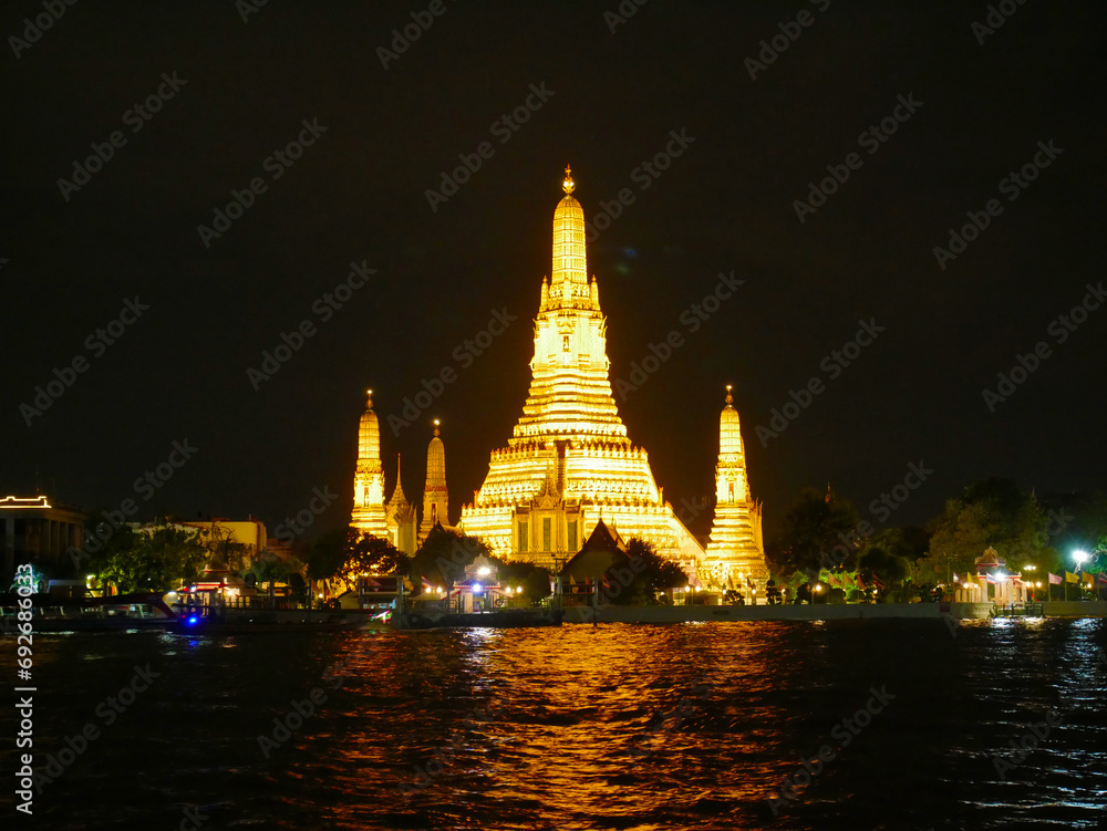 Wat Arun Temple illuminated in the evening in Bangkok