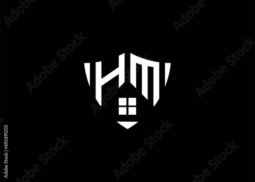 Real estate letter HM shield shape logo and house building vector template