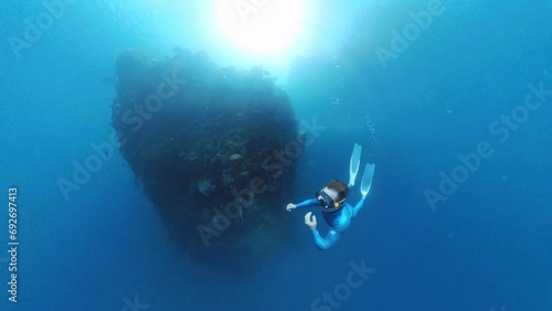 Wallpaper Mural Freediver swims underwater near the rock Torontodigital.ca