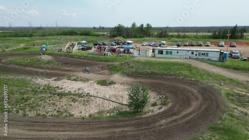 dirt bike riders on track clear skies out of focus with grain motorbikes mx