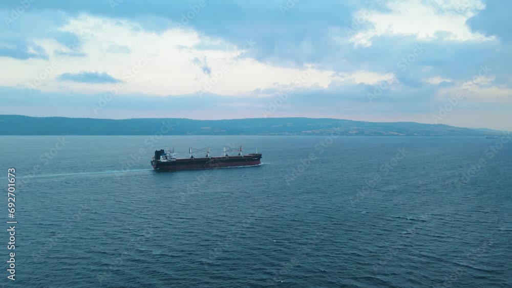 Aerial view of dry cargo bulk carrier ship underway through Dardanelles Strait, concept worldwide logistic and global trade Aerial view of dry cargo bulk carrier ship underway through Dardanelles Strait, concept worldwide logistic and global trade