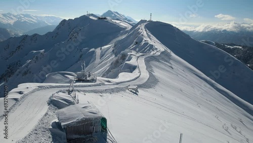 Aerial: a road laid by a snowcat along a mountain ridge against