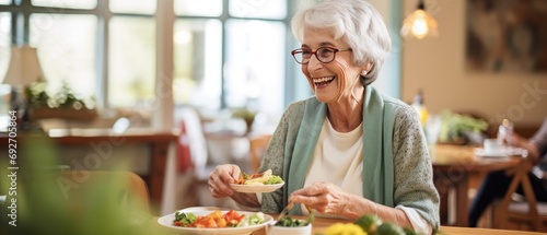 Elderly woman enjoying fresh salad at home. Healthy eating for seniors. photo