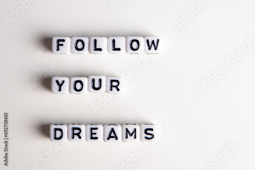 Принти на полотні white cubes and miniature leisure figurines with follow your dreams concept, liv