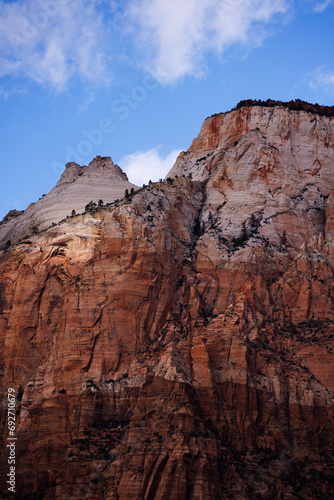 red and white mesas under a blue sky, zion national park © Byron Doyle-Zerbo