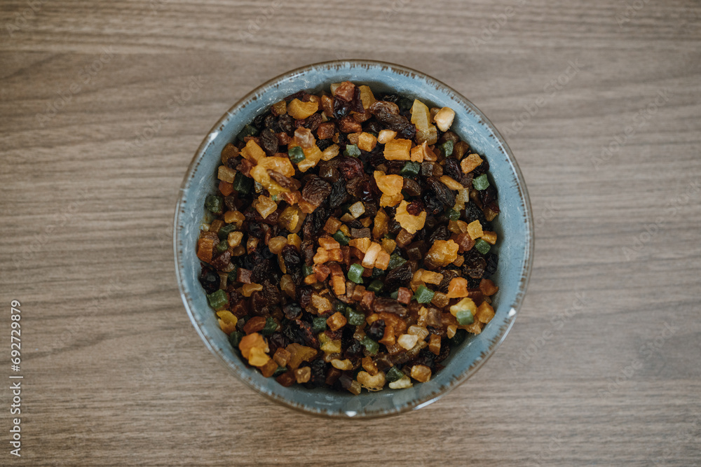 Top view of bowl with raisins and candied fruit for fruitcake. Top view of bowl with raisins and candied fruit for fruitcake.