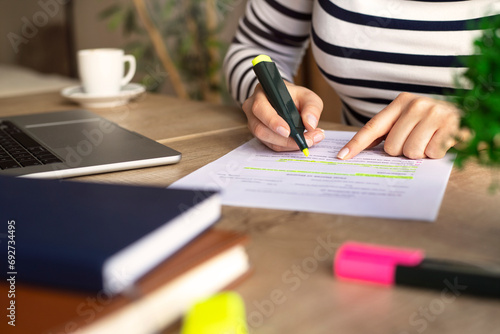 Slika na platnu Unrecognizable businesswoman's hands highlighting important things on paper document
