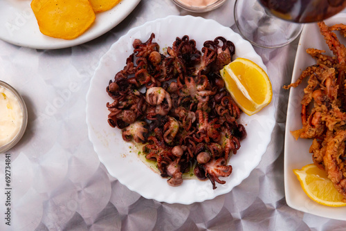 Fried octopus dish with vegetables and wine. High quality photo