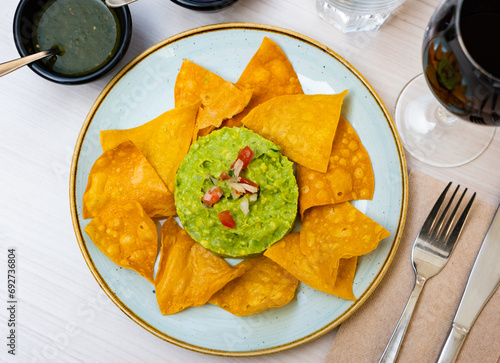 Corn chips with guacamole sauce. Mexican food