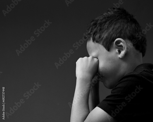 little boy praying to God with hands together with people stock image stock photo