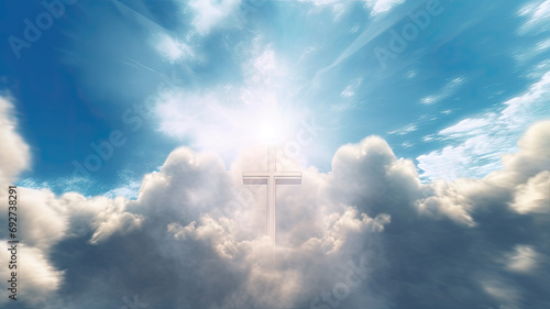 Religious background with cross of God with light rays coming from the clouds in blue sky photo