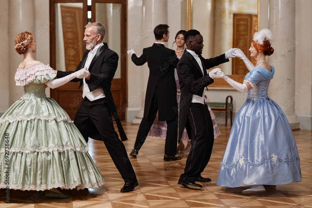 Full length portrait of three couples dancing waltz in classic palace ballroom, copy space - obrazy, fototapety, plakaty 
