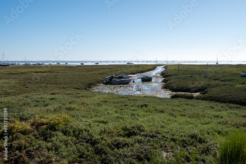 View on Arcachon Bay at low tide with many fisherman's boats and oysters farms, Cap Ferret peninsula, France, southwest of Bordeaux along France's Atlantic coastline photo