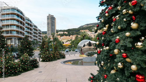 Captivating December scene in Monaco, France. Christmas tree and festive decorations adorning the area in front of Monte Carlo Casino, the holiday spirit and seasonal charm., Festive cityscape 
