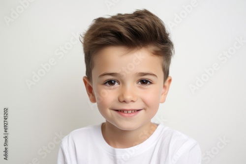 Close-up portrait of a cute little boy on a white background