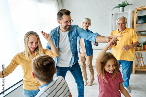 child family woman mother man father grandmother dancing music daughter group happy girl grandparent generation  grandchild together senior grandfather photo