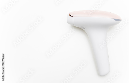 Photo of a pulsed light hair removal gun on a white background.Pulsed light laser.IPL.Copyspace for advertising photo