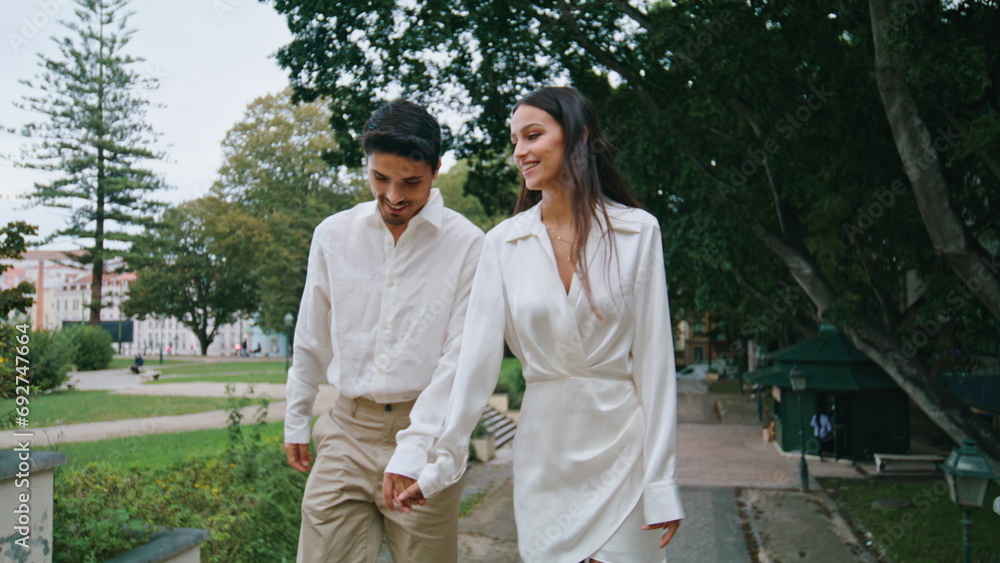 Romantic couple walking stairs outdoors. Hispanic pair enjoying date at nature Romantic couple walking stairs outdoors. Hispanic pair enjoying date at nature