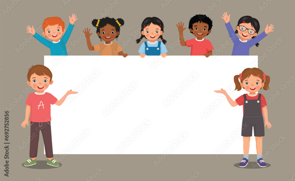 Group of kids students boys and girls standing behind empty banner or ...