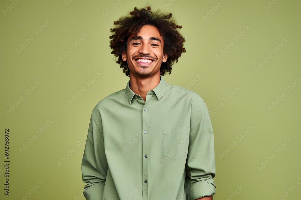 Portrait of a happy young african american man with curly hair on green background Portrait of a happy young african american man with curly hair on green background