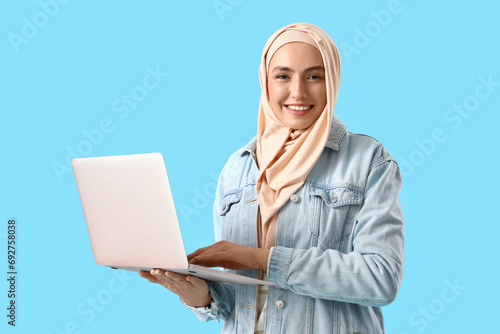 Young Muslim woman with lap...