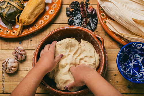 Person kneading nixtamalized corn dough to prepare tamales. Typical Mexican food. photo